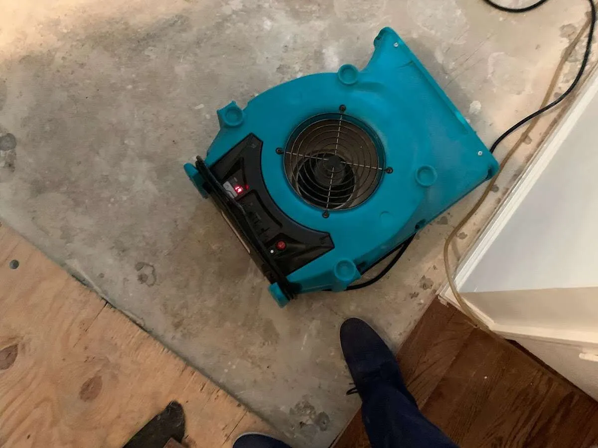 Air mover drying subfloor during Commercial Water Damage Restoration in Marana